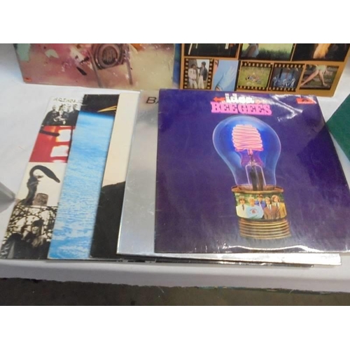 1329 - A collection of LP records including The Who, Journey, Bee Gees, signed IPI Tombi album etc.,