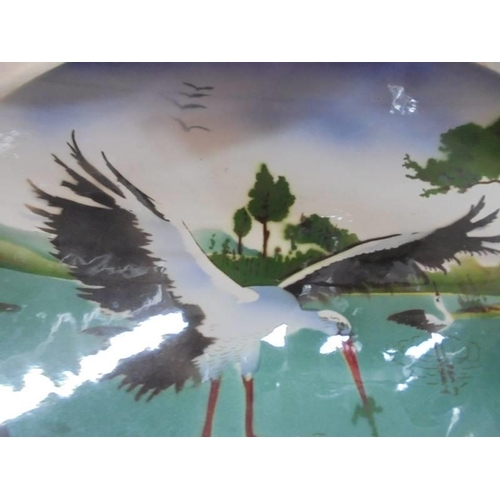 1340 - A large ceramic wall plaque featuring storks.