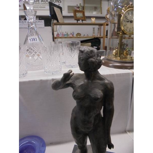 1394 - A heavy metal nude figure on a marble base.