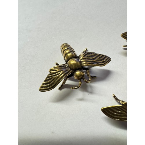 1078 - Four unusual brass bees.