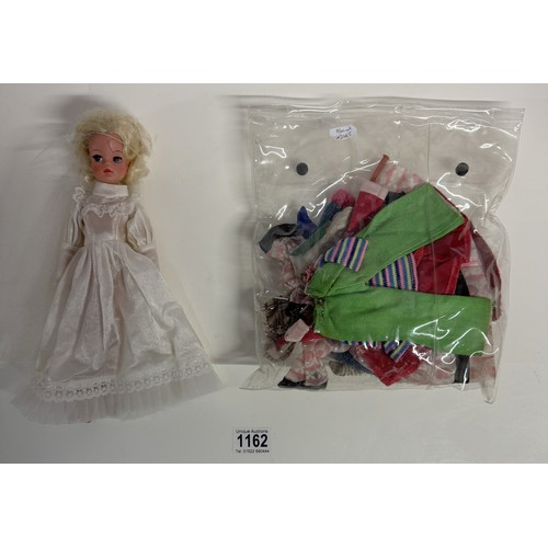 1162 - A Sindy doll in wedding dress and a quantity of vintage Sindy clothes.