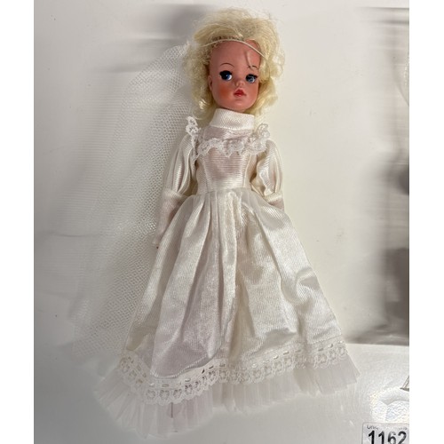 1162 - A Sindy doll in wedding dress and a quantity of vintage Sindy clothes.