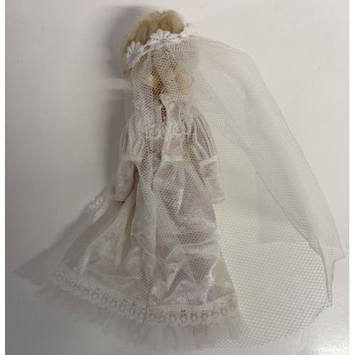 1162 - A Sindy doll in wedding dress and a quantity of vintage Sindy clothes.