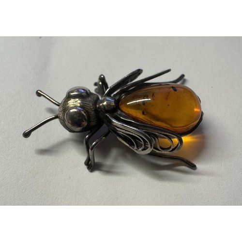 1062 - A silver and amber 'BEE' brooch.