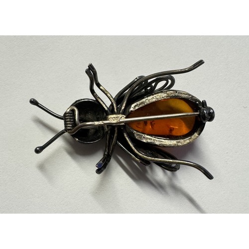 1062 - A silver and amber 'BEE' brooch.