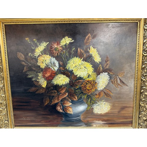 1366 - A gilt framed oil on board painting of a floral arrangement,