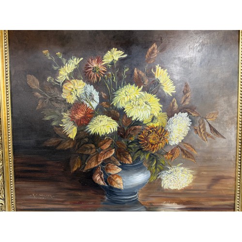 1366 - A gilt framed oil on board painting of a floral arrangement,