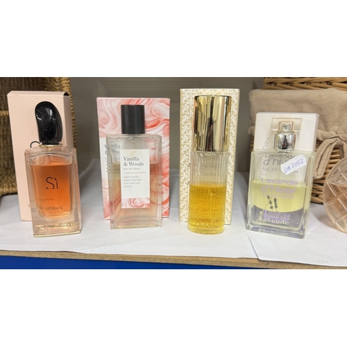 1045 - A wicker bottle basket & 1 other & a quantity of used & unused perfumes