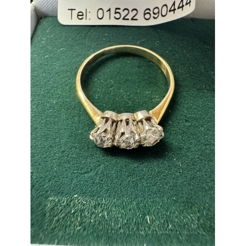 1003 - An 18ct 3 stone yellow gold diamond ring. Size N