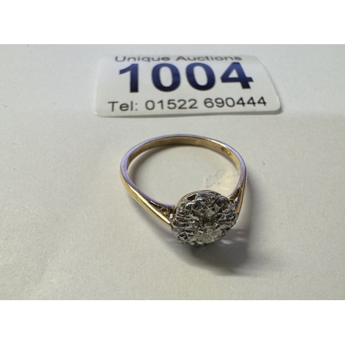 1004 - An 18ct yellow gold floral diamond ring. 2.86 grams. Size P