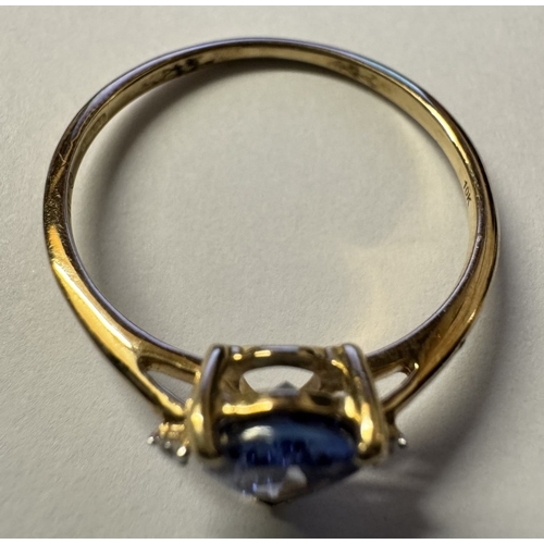 1011 - A yellow gold good colour tanzanite diamond ring. Size P