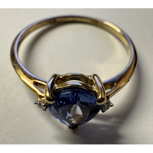 1011 - A yellow gold good colour tanzanite diamond ring. Size P