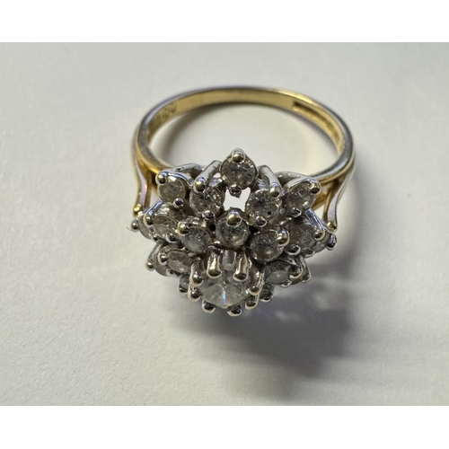 1014 - An 18ct white gold diamond 1ct daisy ring. Centre stone raised. 4.4g. Size N