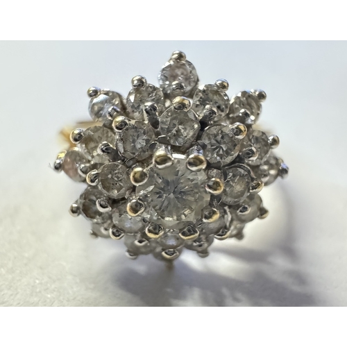 1014 - An 18ct white gold diamond 1ct daisy ring. Centre stone raised. 4.4g. Size N