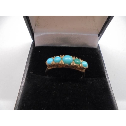 1028 - A 9ct gold ring set five turquoise stones, size P half, 2.26 grams.