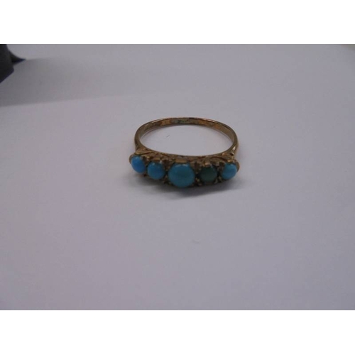 1028 - A 9ct gold ring set five turquoise stones, size P half, 2.26 grams.