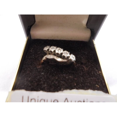 1030 - An 18ct gold and platinum ring set five small diamonds, size O. 3.12 grams.