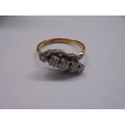 1030 - An 18ct gold and platinum ring set five small diamonds, size O. 3.12 grams.