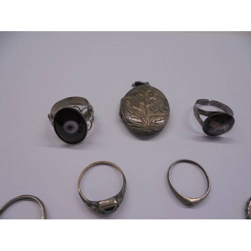 1038 - A silver locket, three silver rings etc.,