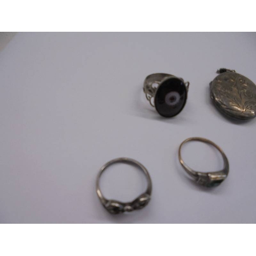 1038 - A silver locket, three silver rings etc.,