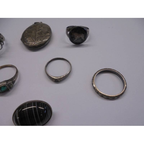 1038 - A silver locket, three silver rings etc.,