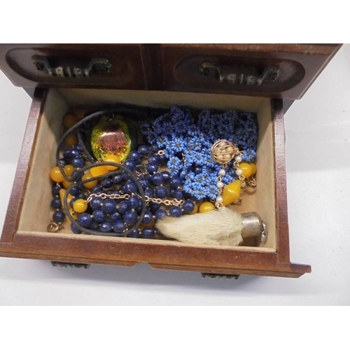 1116 - A jewellery box with assorted rings, earrings, necklaces etc.,