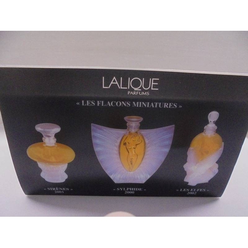 1201 - A set of three Lalique perfume bottles with contents (box incomplete).