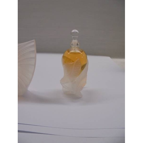 1201 - A set of three Lalique perfume bottles with contents (box incomplete).