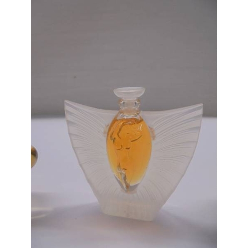 1201 - A set of three Lalique perfume bottles with contents (box incomplete).