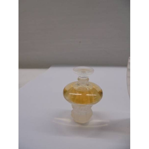 1201 - A set of three Lalique perfume bottles with contents (box incomplete).