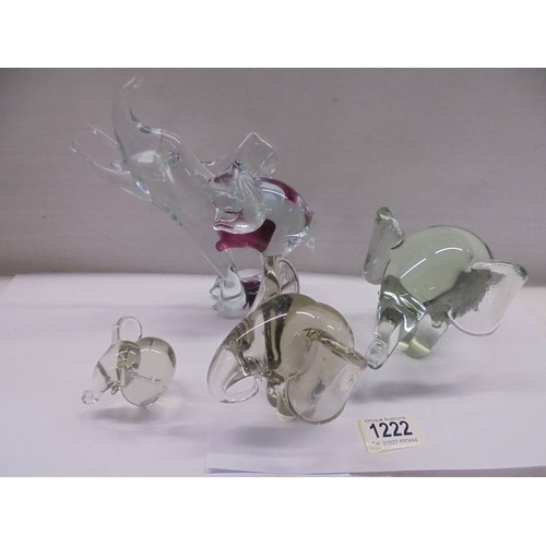 1222 - A set of three heavy glass elephants and one other.