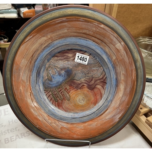 1480 - A large studio pottery terracotta charger by Jodie Watten. Diameter 41cm