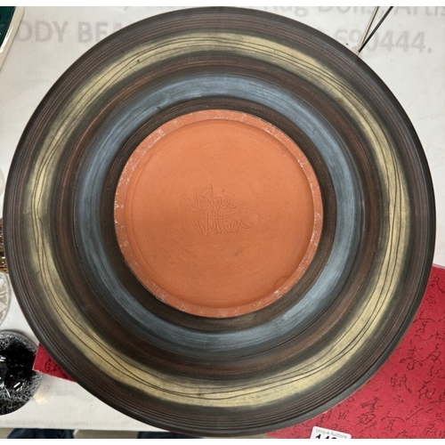 1480 - A large studio pottery terracotta charger by Jodie Watten. Diameter 41cm
