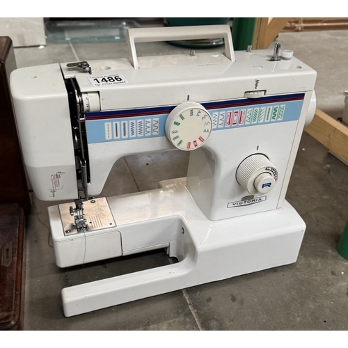 1486 - A Victorian cast iron sewing machine decorated with mother of pearl & An electric sewing machine wit... 