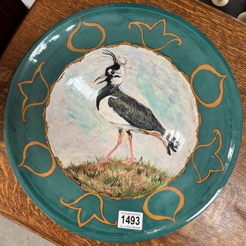 1493 - A large ceramic charger bowl with hand painted Wader bird decoration. Diameter 38.5cm