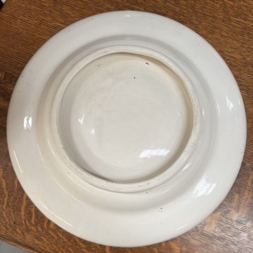 1493 - A large ceramic charger bowl with hand painted Wader bird decoration. Diameter 38.5cm