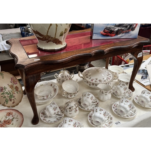1615 - A mahogany glass top coffee table