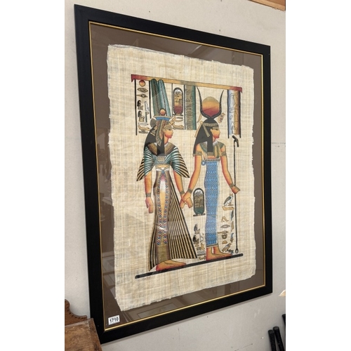 1710 - A large framed and glazed study of Egyptian figures on papyrus.
