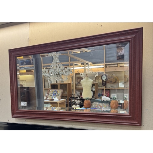 1712 - A framed bevel edged mirror 78 x 44cm
