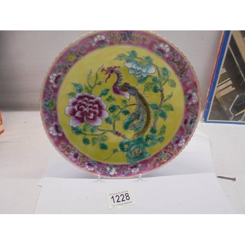 1228 - A Nyonga Peranakan Chinese porcelain plate with Pheonix design on yellow ground.