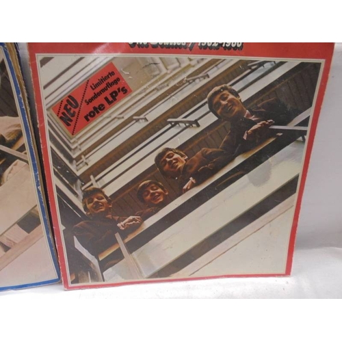 1230 - A Beatles album on red vinyl 1962-1966 (only on disc) and a Beatles album of blue vinyl with two dis... 