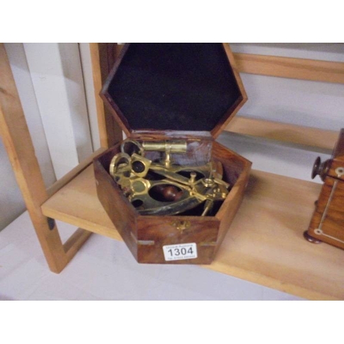 1304 - A brass sextant in mahogany case.