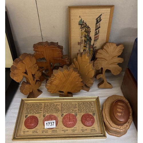 1737 - Some carved wood items. The wood types are represented by the tree shapes. (One with town seals)