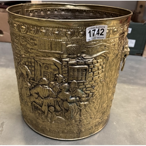 1742 - An impressed brass cylindrical coal scuttle with lion face handles. Diameter 28cm, height 29cm