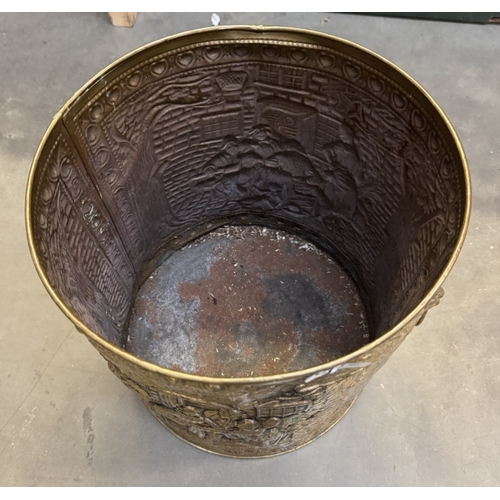 1742 - An impressed brass cylindrical coal scuttle with lion face handles. Diameter 28cm, height 29cm