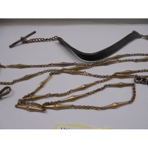 1053 - A silver watch chain and two other watch chains.