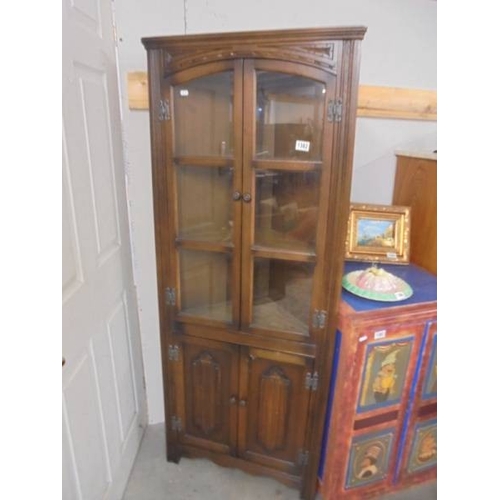 1382 - An oak cottage style corner cabinet with glazed doors.