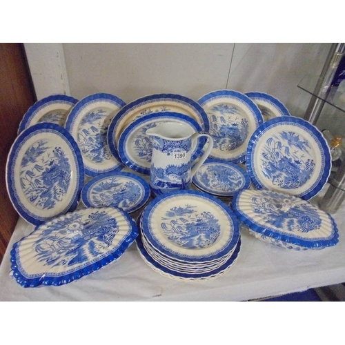 1390 - A quantity of blue and white willow pattern dinnerware (in excess of 20 pieces).