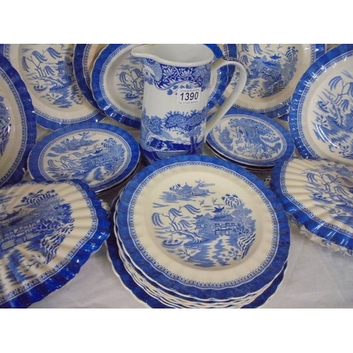 1390 - A quantity of blue and white willow pattern dinnerware (in excess of 20 pieces).