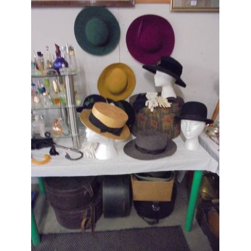 1394 - A good collection of vintage hats and hat boxes including bowler hat, straw boater etc.,